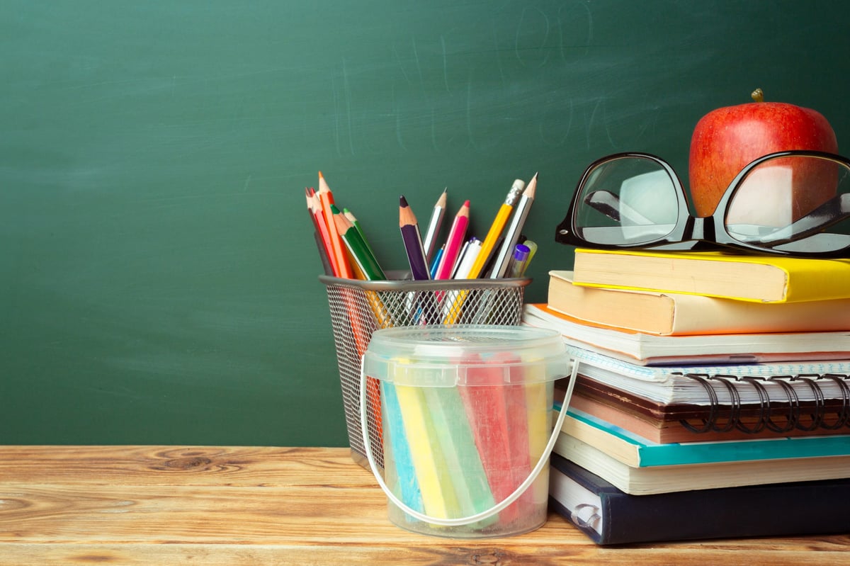 Stationery and teacher tools arranged neatly on a desk