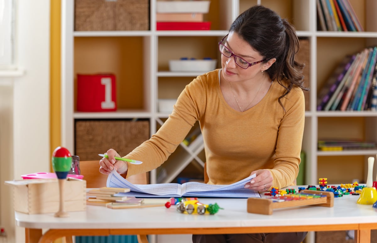 A teacher planning custom materials at a workspace